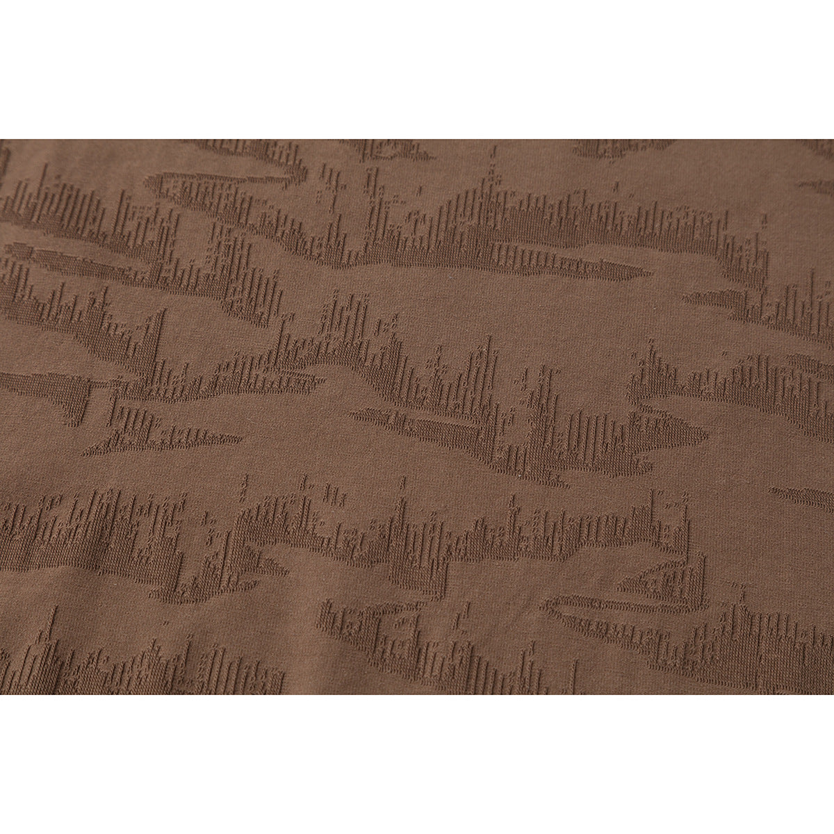 Close-up of the brown T-shirt's subtle raised geometric fabric pattern.