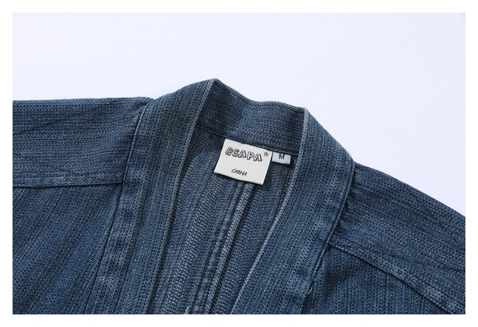 Close-up of a blue denim jacket collar and sewn-in labels marked BSAPA, size M, and CHINA.