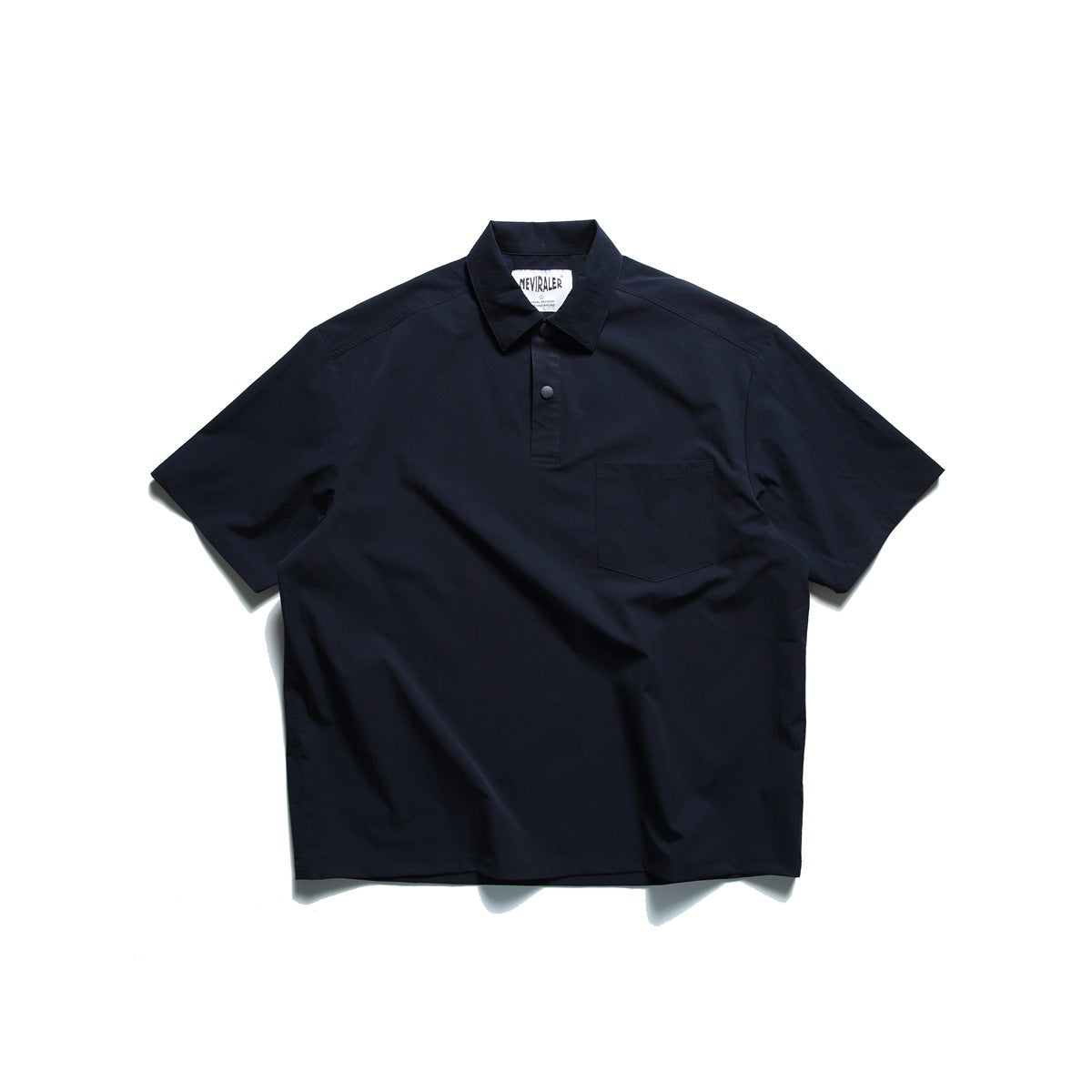 Navy short-sleeve polo-style top flat lay with collar, snap placket and chest pocket