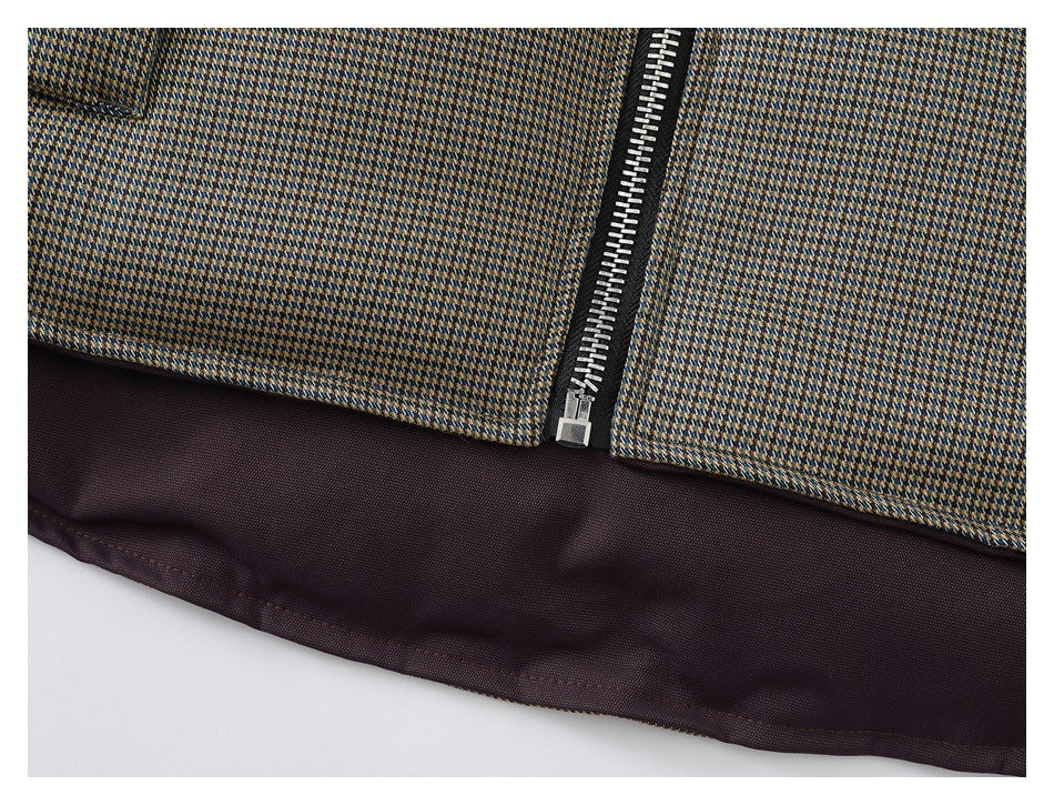 Close-up of the patterned jacket's lower edge, silver zipper, and dark brown lining.