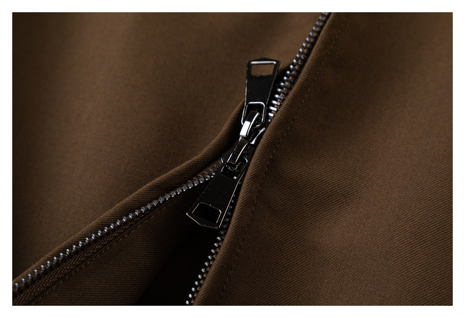 Close-up of the jacket's dark metal front zipper and brown fabric.