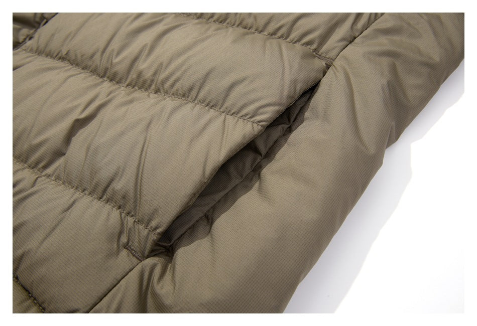 Close-up of the taupe jacket's horizontal quilted panels and side seam.