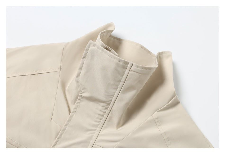 Close-up of a cream garment's tall collar and overlapping front closure.