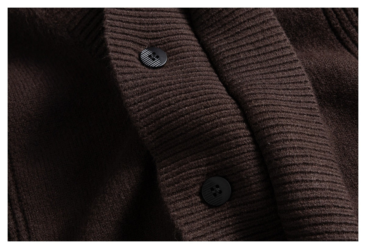 Close-up of a dark brown knit cardigan's ribbed button placket with two black buttons.