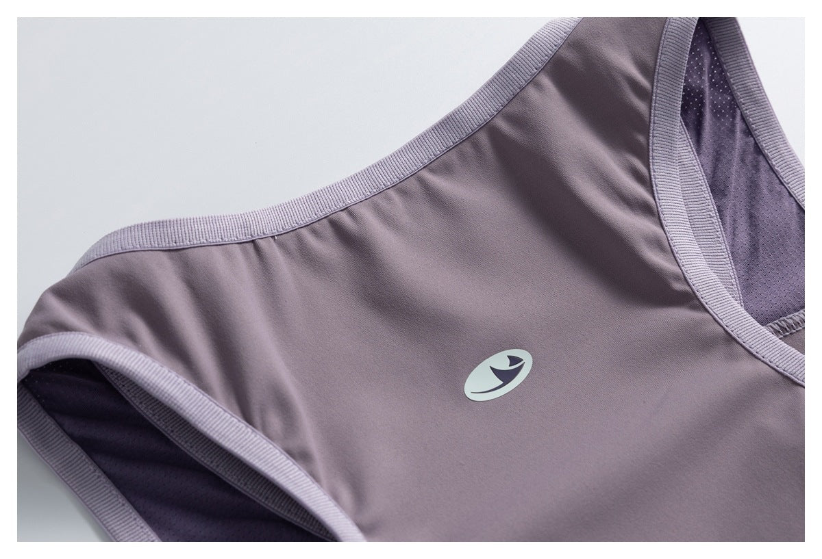 Close-up of a mauve athletic top showing ribbed edging, mesh lining, and a small pale logo.