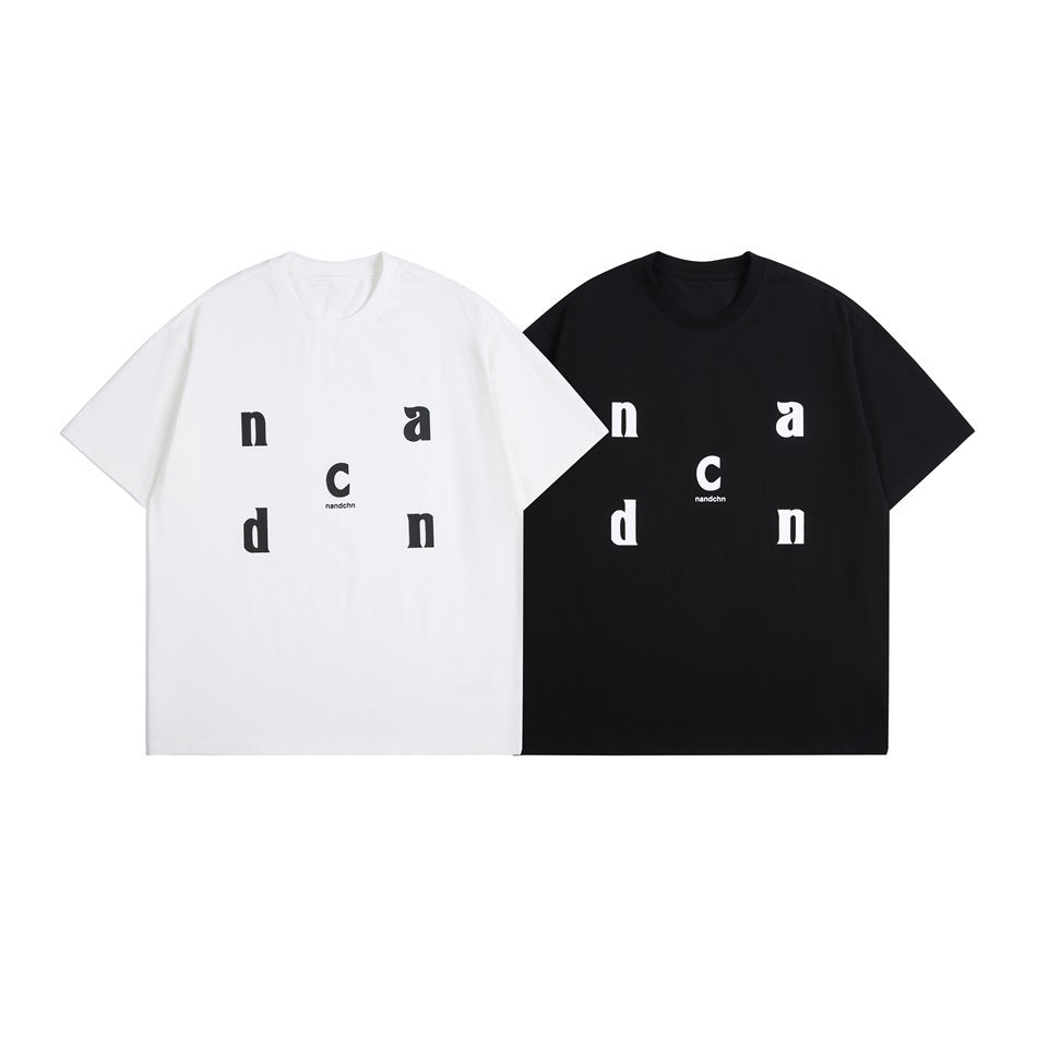 White and black short-sleeve crew-neck T-shirts shown from the front, each with scattered contrasting letters.