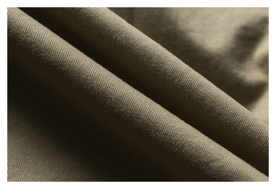 Macro view of olive-khaki fabric folded to show its surface texture.