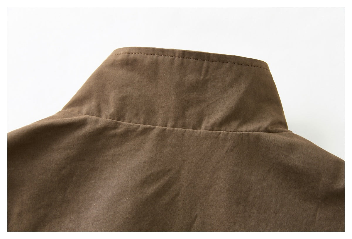 Close-up of the back of a brown jacket, showing its high stand collar and shoulder seams.