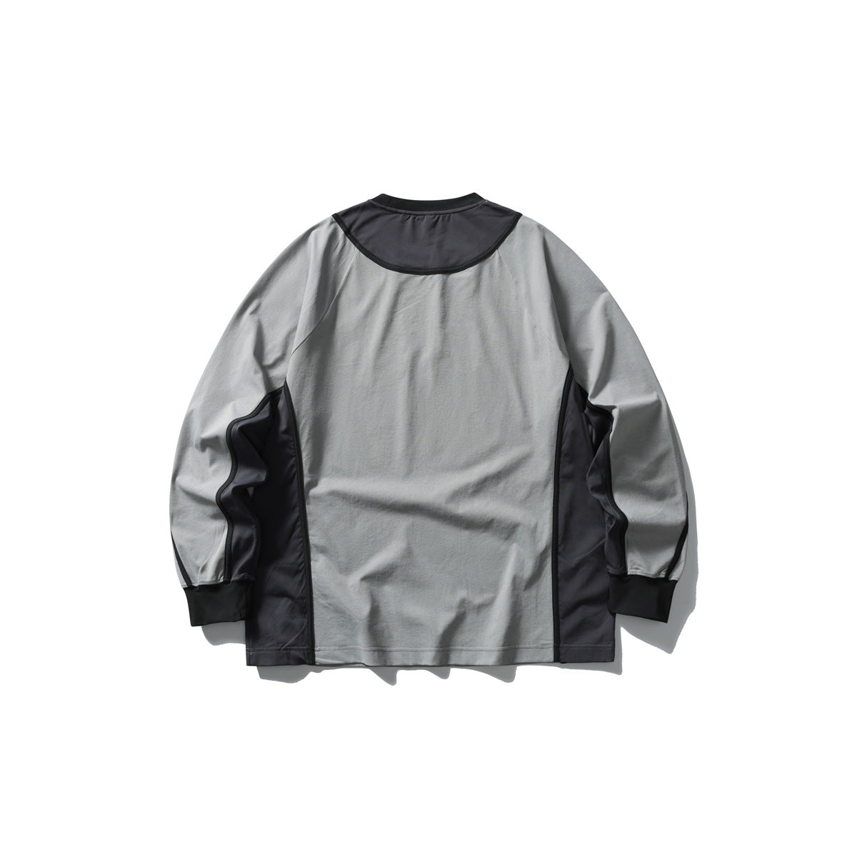 Back of a gray long-sleeve shirt with dark charcoal shoulder and side panels, contrast piping, and dark cuffs.