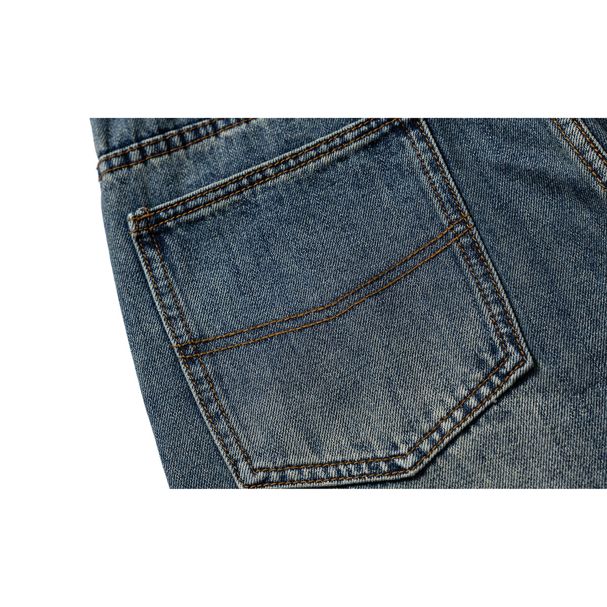 Close-up of a rear patch pocket on blue-wash jeans with contrast stitching.