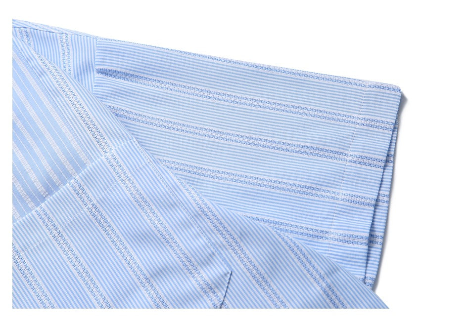 Close-up of light blue and white striped shirt fabric with alternating fine and textured bands.