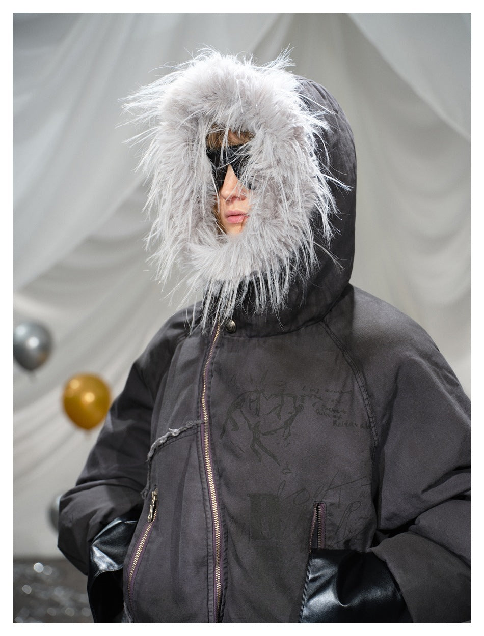 Close view of a model wearing a dark hooded jacket with a large pale fur trim, front zipper and pockets.