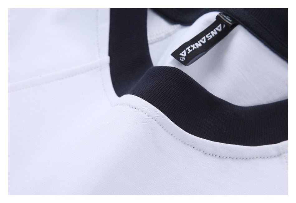 Close-up of the shirt's black ribbed neckline, white stitching, and black neck label.