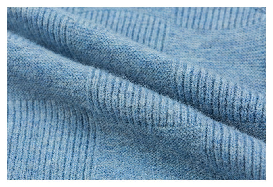 Close-up of the light blue cardigan's textured knit and thick ribbed edging.