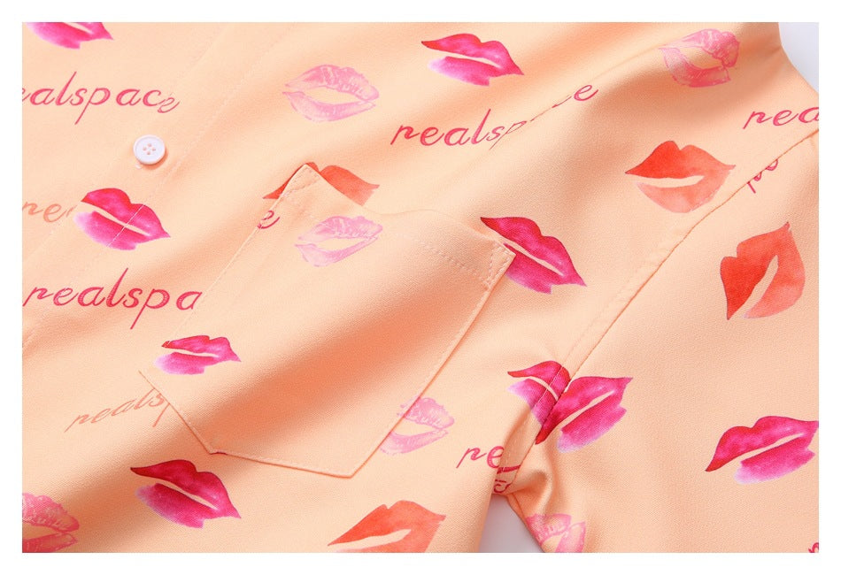 Peach lip-print garment close-up showing a button and a rectangular patch pocket.
