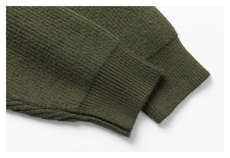 Close-up of an olive green rib-knit cuff and garment edge.