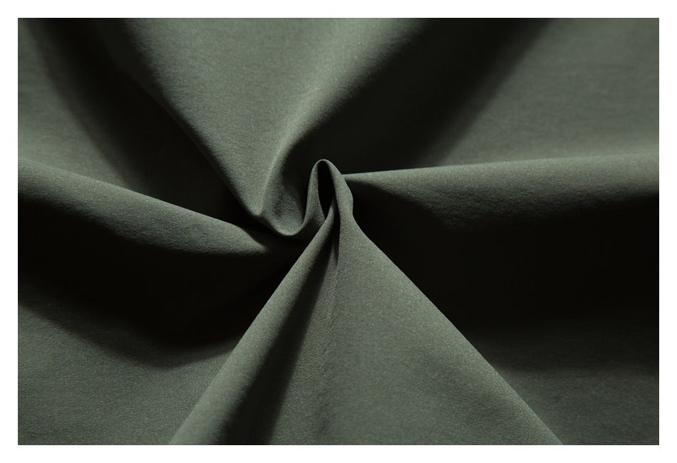 Close-up showing the smooth drape and folds of dark olive-green garment fabric.