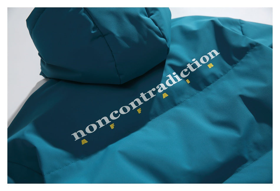 Teal jacket back with white and yellow “noncontradiction” lettering printed on the fabric.