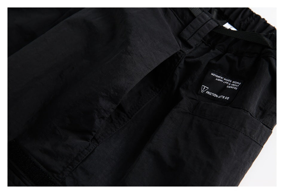 Close-up of black garment waistband, straps, and a small English-text label.