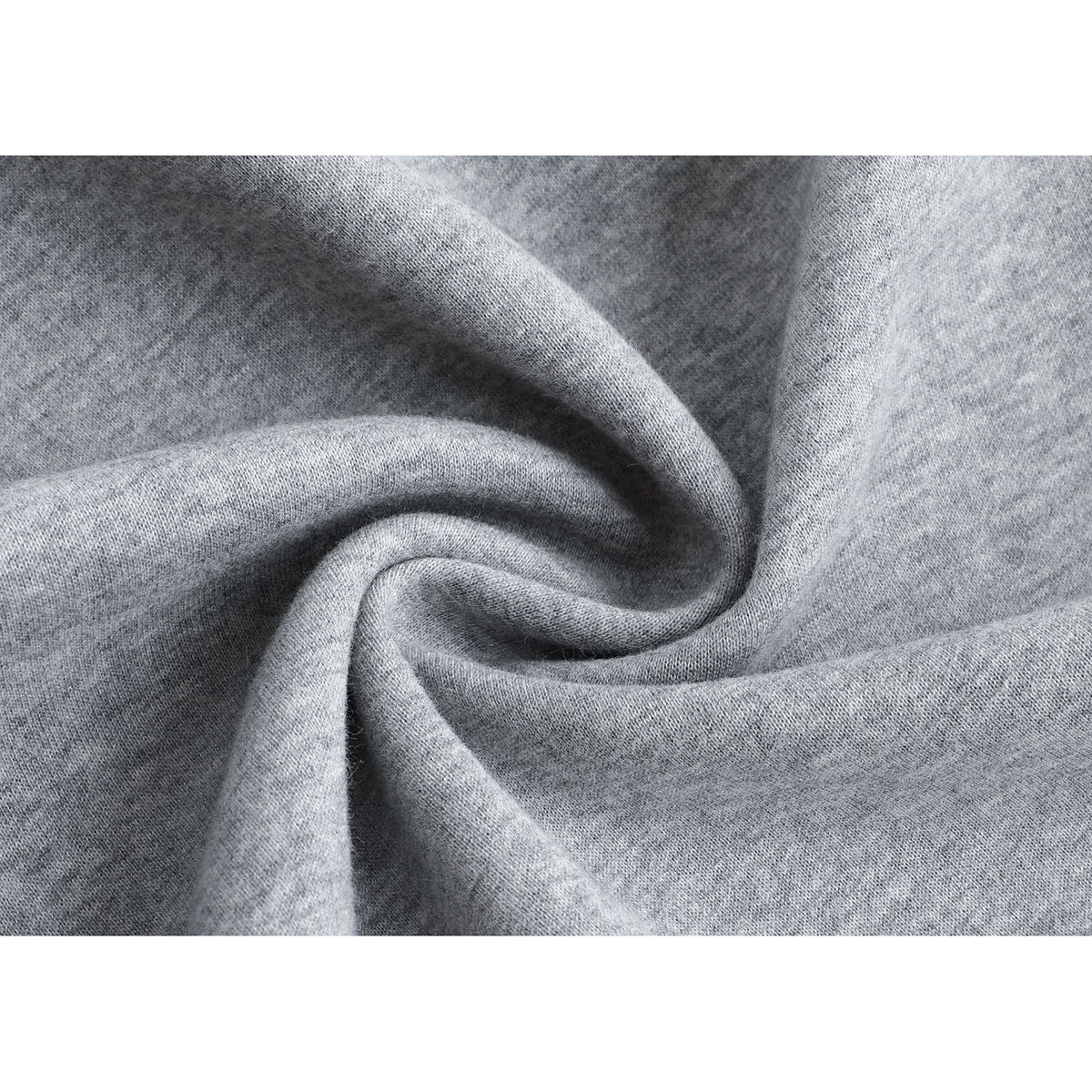 Close-up of light gray knit fabric gathered into soft folds.