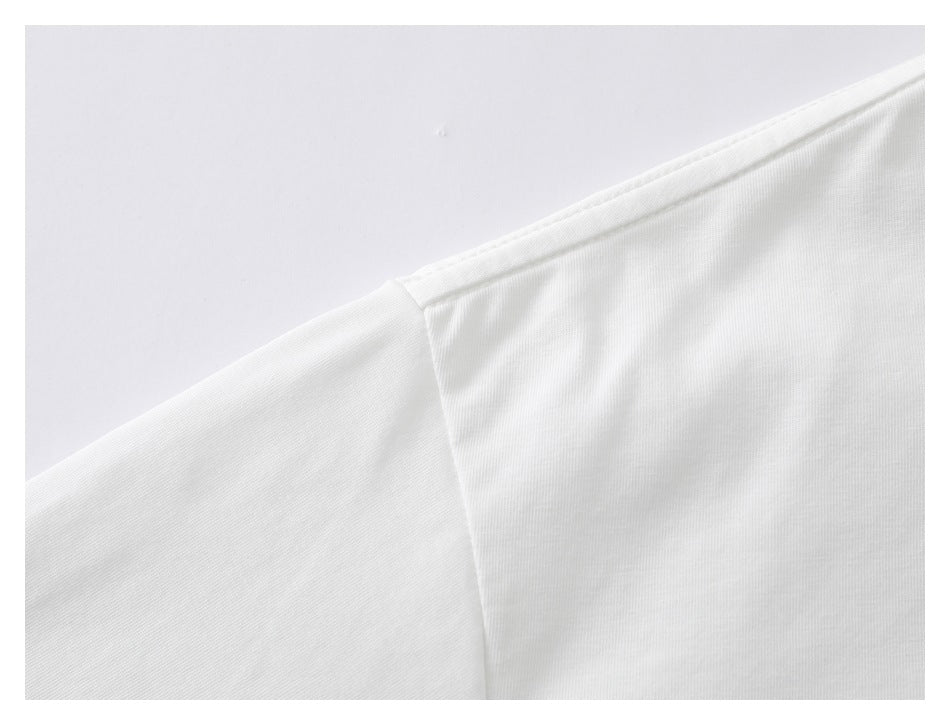 Close-up of the white T-shirt's shoulder seam and stitching.