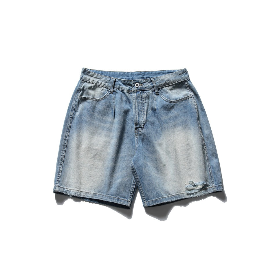 Light blue washed denim shorts flat lay, front view, with faded finish, distressed hem hole and frayed hems