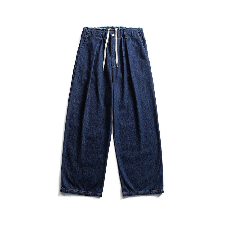 Blue wide-leg denim jeans flat lay with frayed waistband, white drawstring and contrast stitching