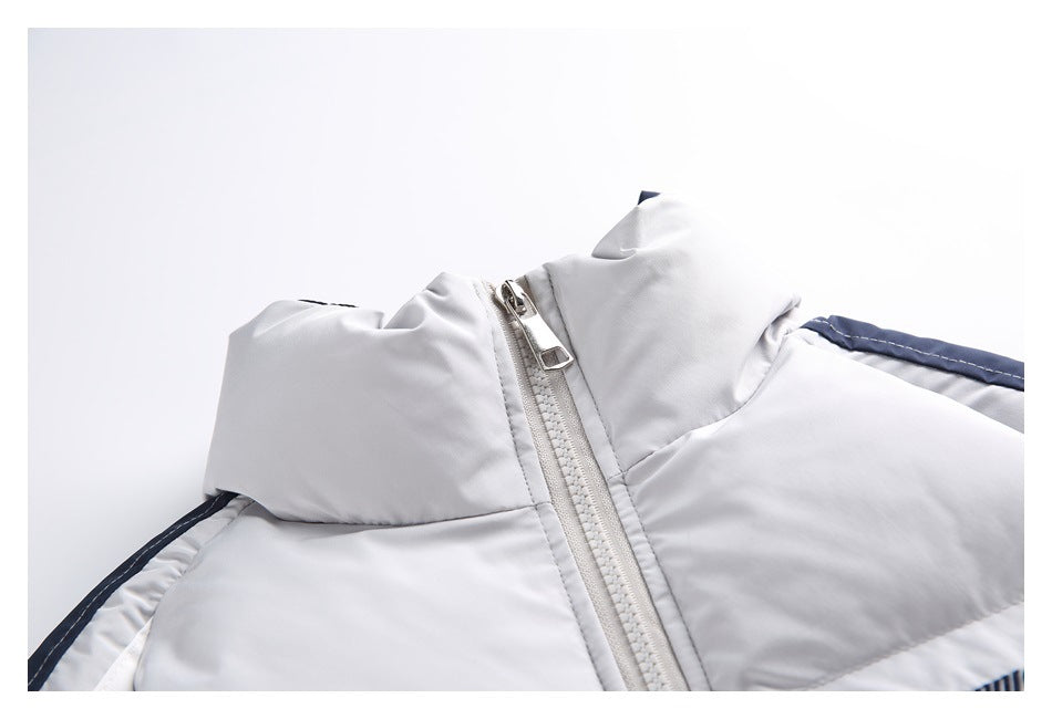 Close-up of the light gray jacket’s raised collar, front zipper, and navy-and-white shoulder stripe.