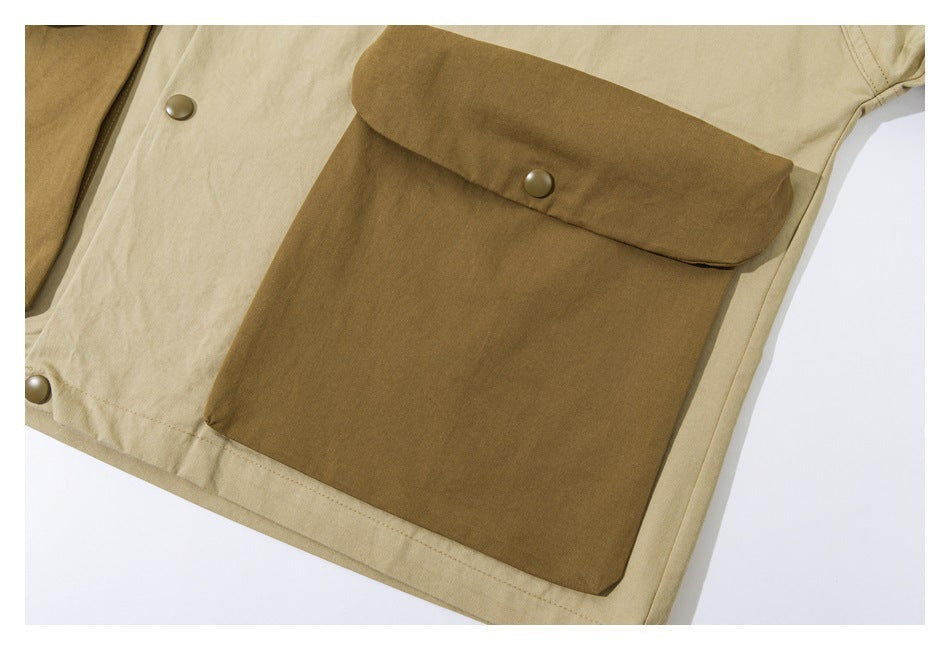 Close-up of a large brown flap pocket with a snap on a beige garment with contrast trim.