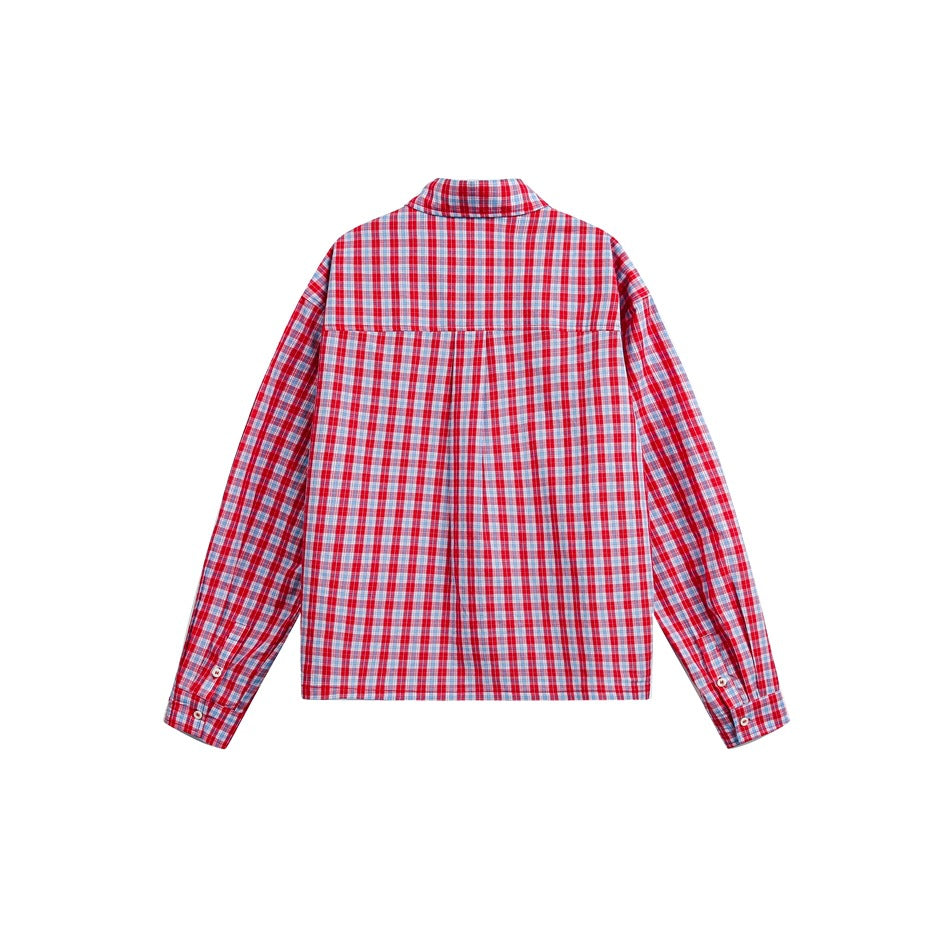 Back view of a red, blue, and white plaid long-sleeve button-up shirt laid flat.