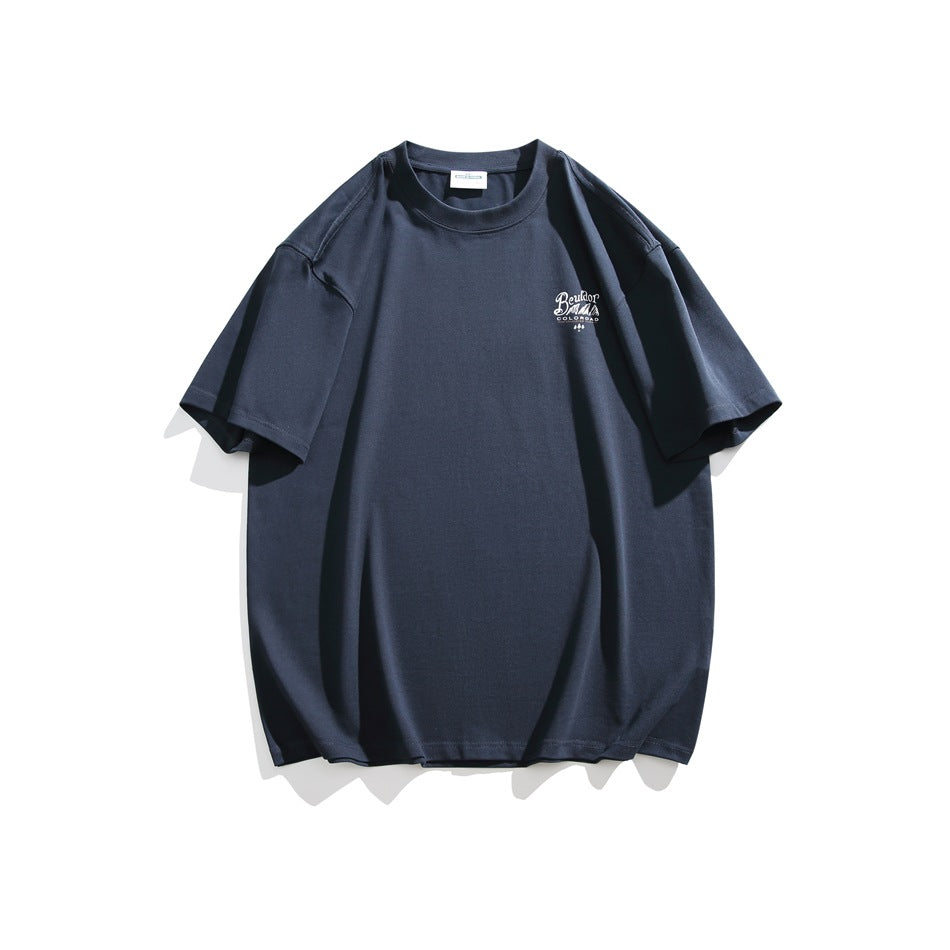 Front of a navy T-shirt with a small light-colored script logo on the left chest.