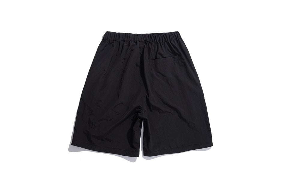 Back of black shorts with an elastic waistband and a single rear pocket.