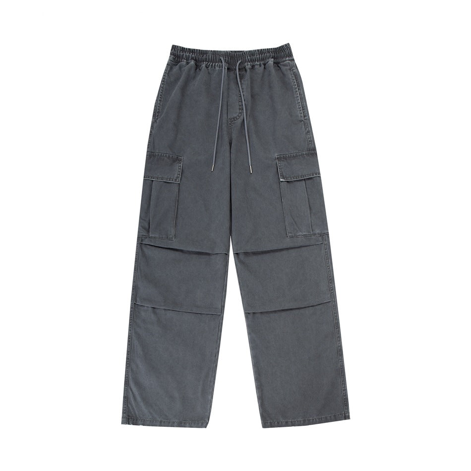 Gray washed wide-leg cargo pants with drawstring waist, thigh flap pockets and knee pleats, flat front view
