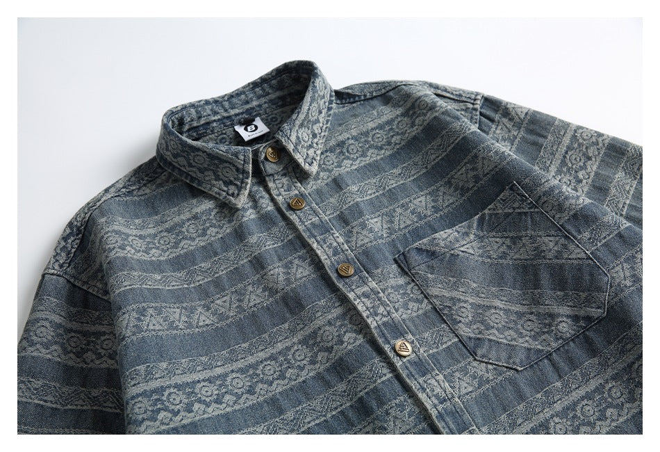 Flat-lay upper-front view of a blue patterned button-up shirt with a chest pocket and pointed collar.