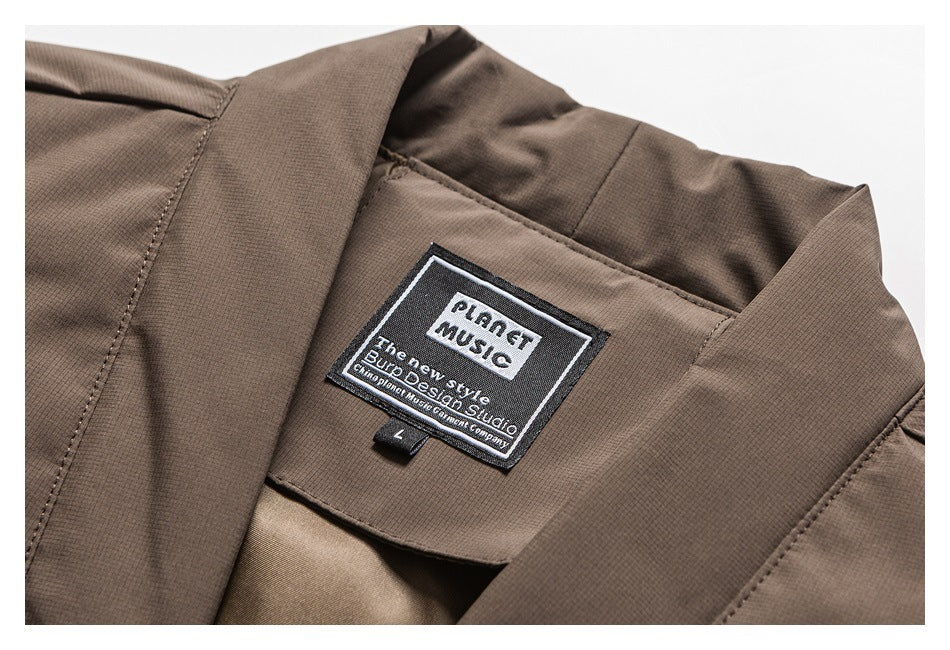 Close-up of the garment's sewn Planet Music label inside a dark brown collar.