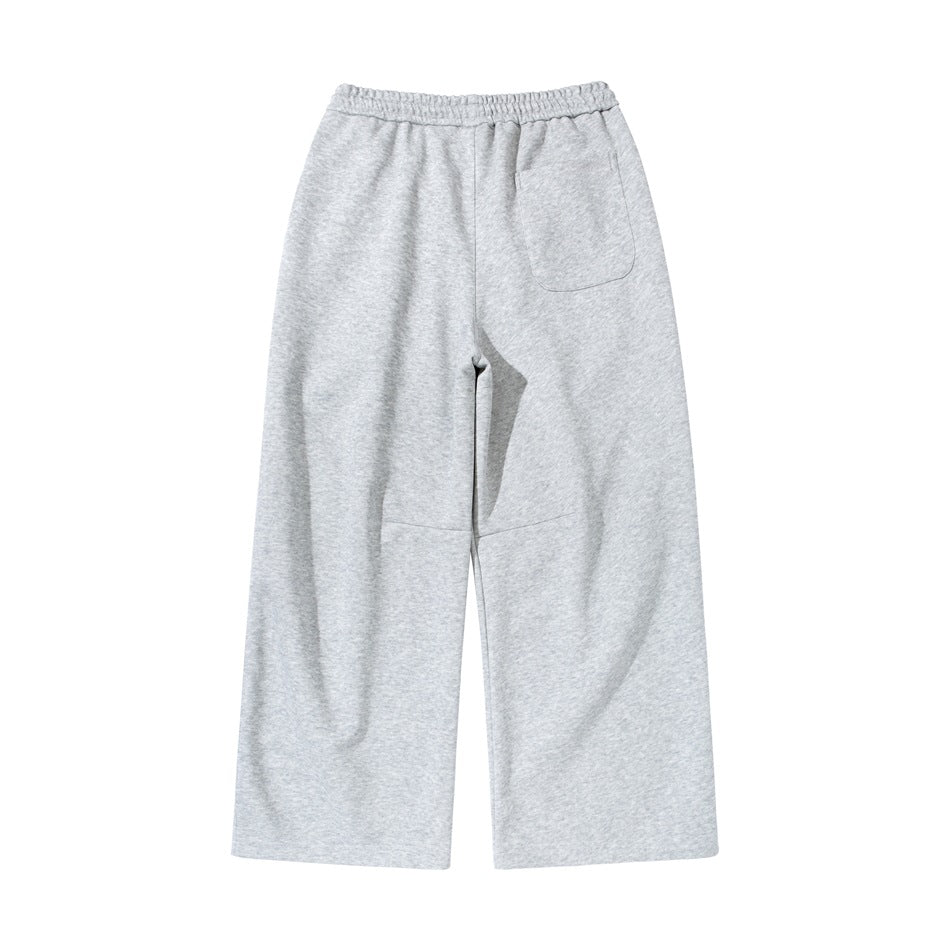 Back view of light gray heather wide-leg sweatpants with an elastic waistband and a single patch pocket.