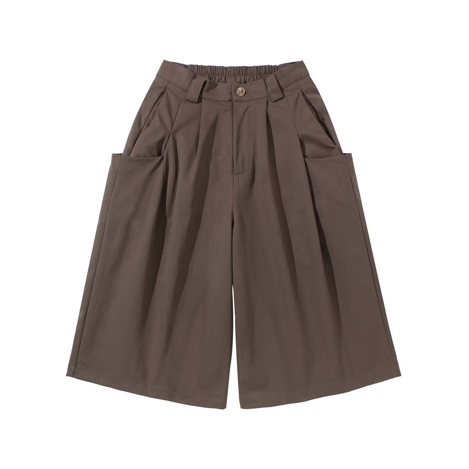 Coffee brown wide-leg pleated knee-length shorts with large side pockets and button front, flat lay