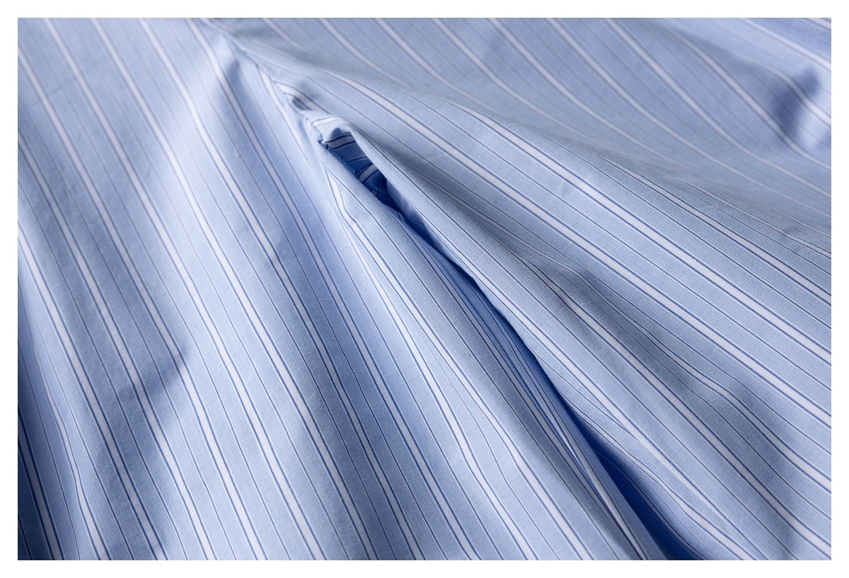 Close-up of a seam and opening in light blue striped shorts fabric.