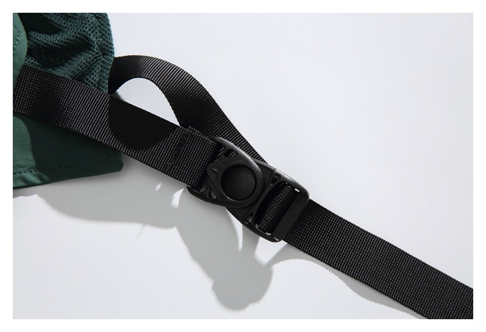 Close-up of a black adjustable webbing strap and buckle attached to dark green mesh fabric.
