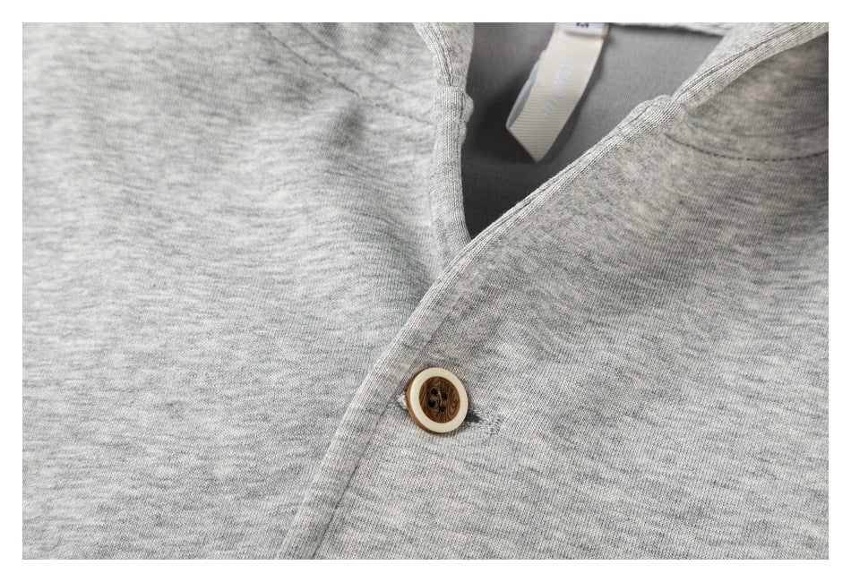 Close-up of the gray marled hoodie’s front overlap and single brown button.