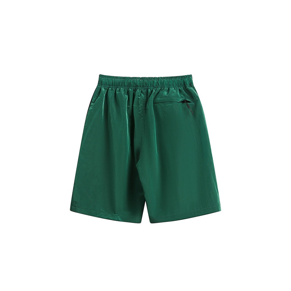 Emerald green shorts shown from the back, with an elastic waistband and a small zip pocket.