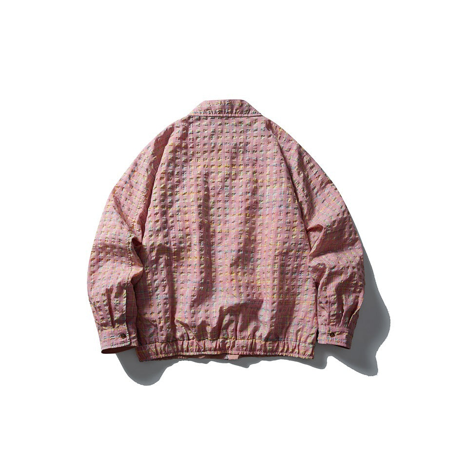 Back view of a pink plaid jacket with a stand collar, long sleeves, button cuffs, and an elasticized hem.