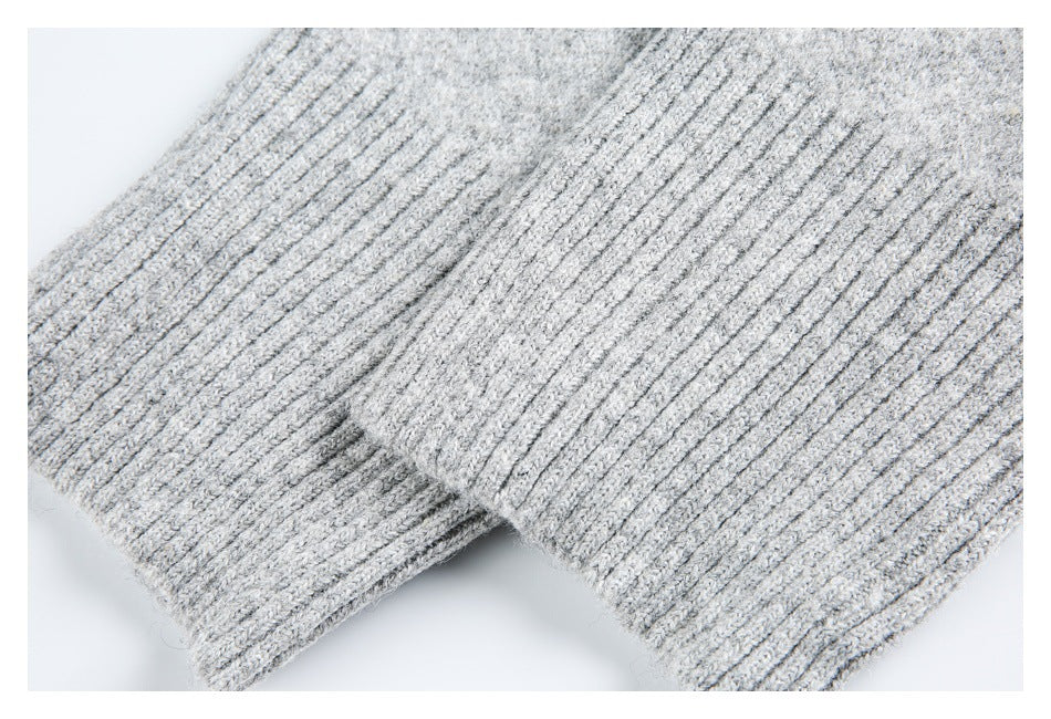 Close-up of overlapping ribbed edges on a light gray knit garment.