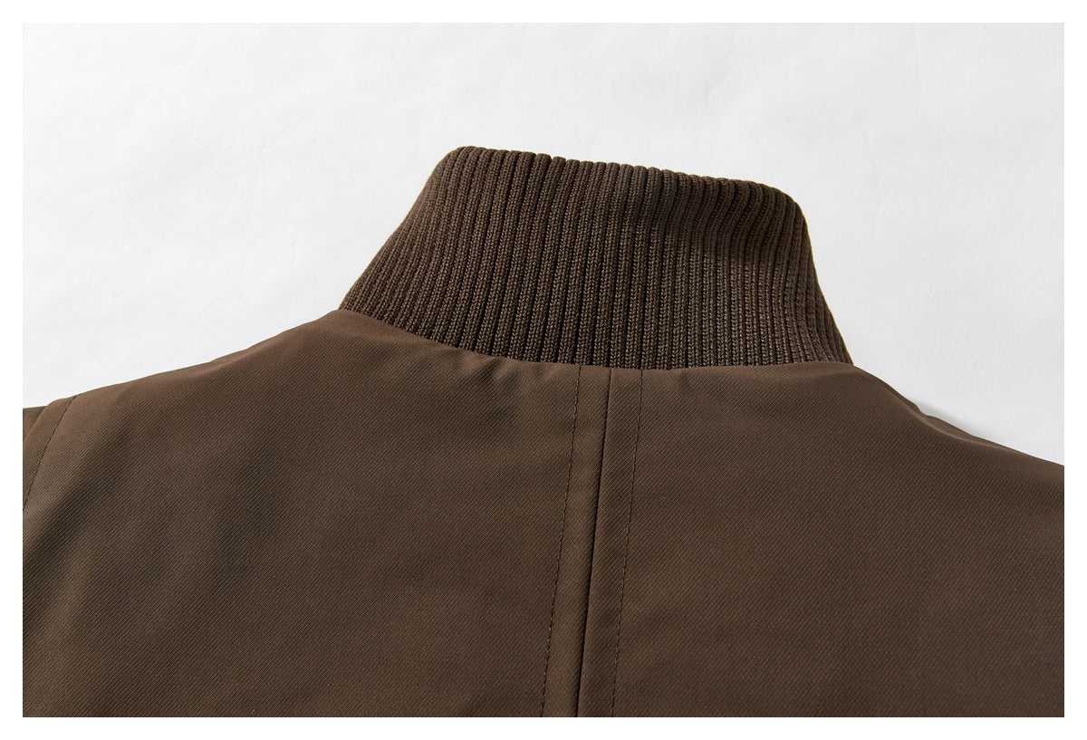 Close-up of the back of a brown jacket showing its ribbed knit collar and center seam.
