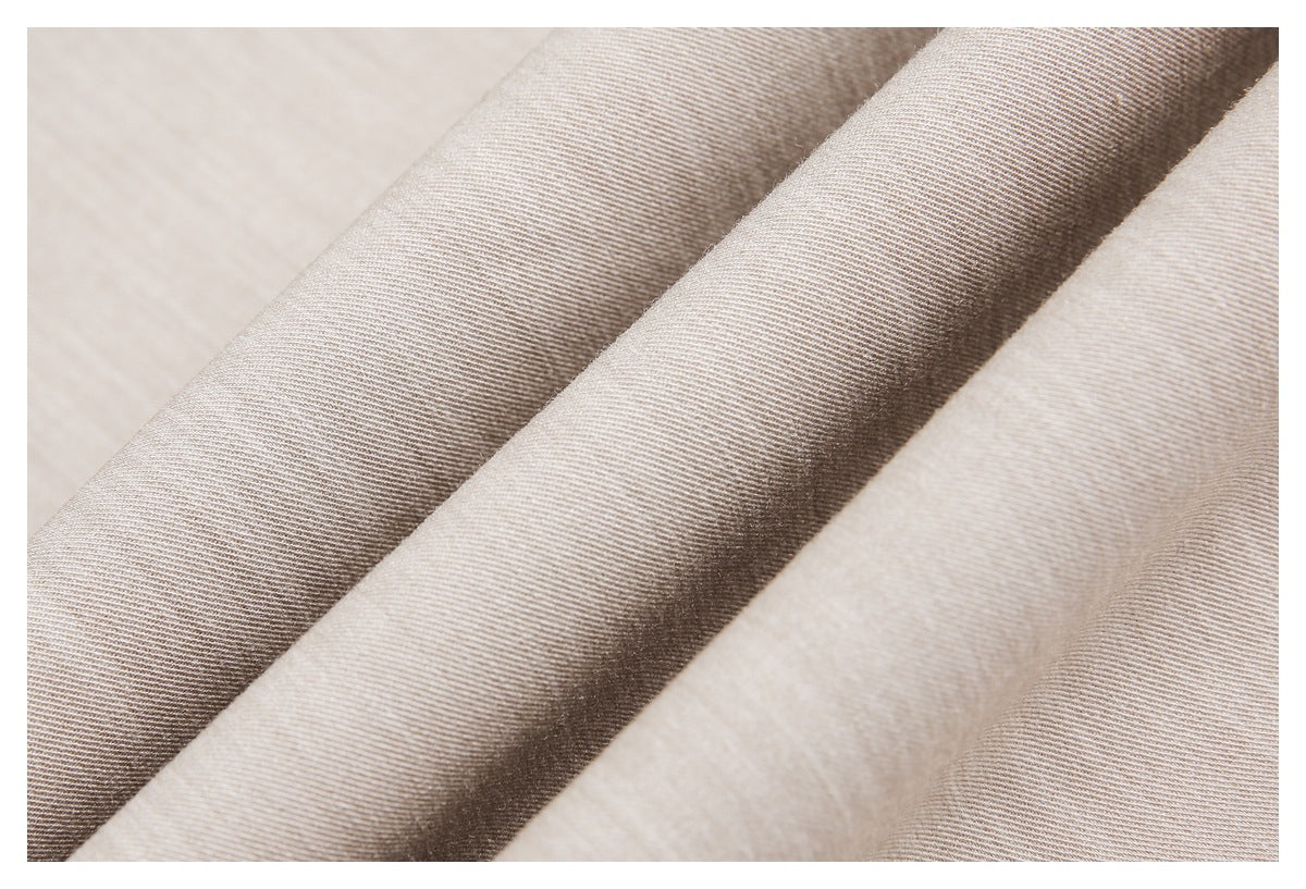 Close-up of beige and taupe woven fabric draped in soft diagonal folds.