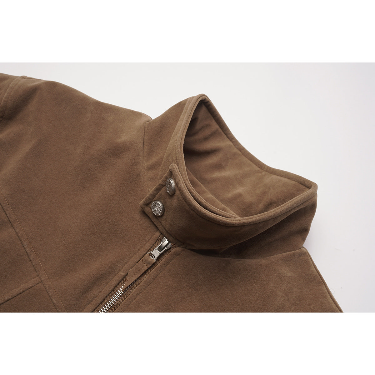 Close-up of a brown jacket's stand collar, snap buttons, and silver front zipper.