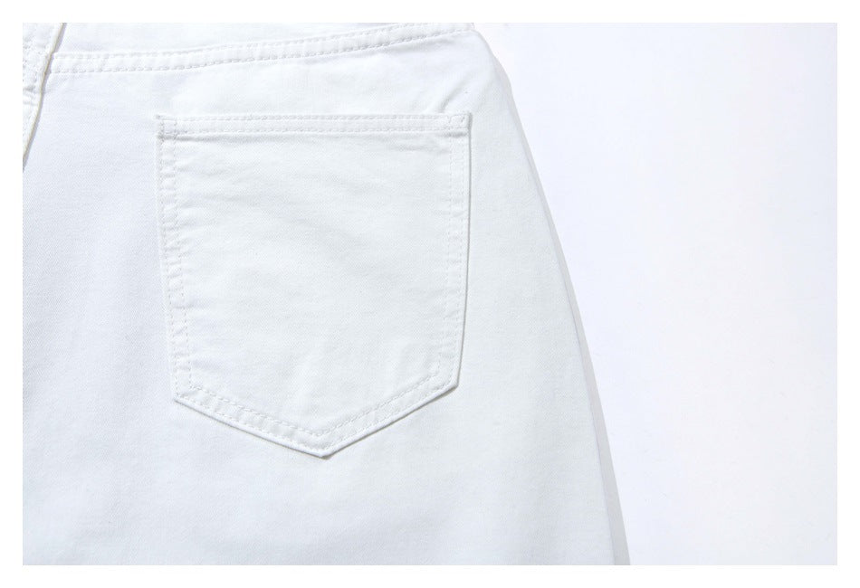 Close-up of white jeans showing a stitched back pocket.