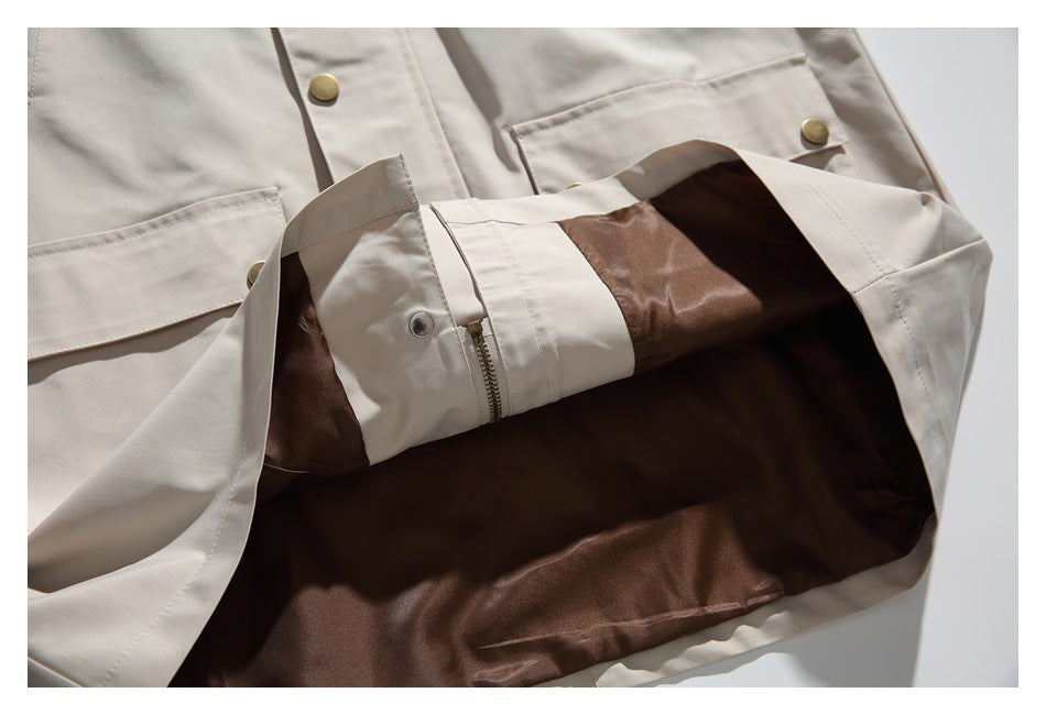 Beige jacket opened to show its dark brown lining and a zipper near the hem.