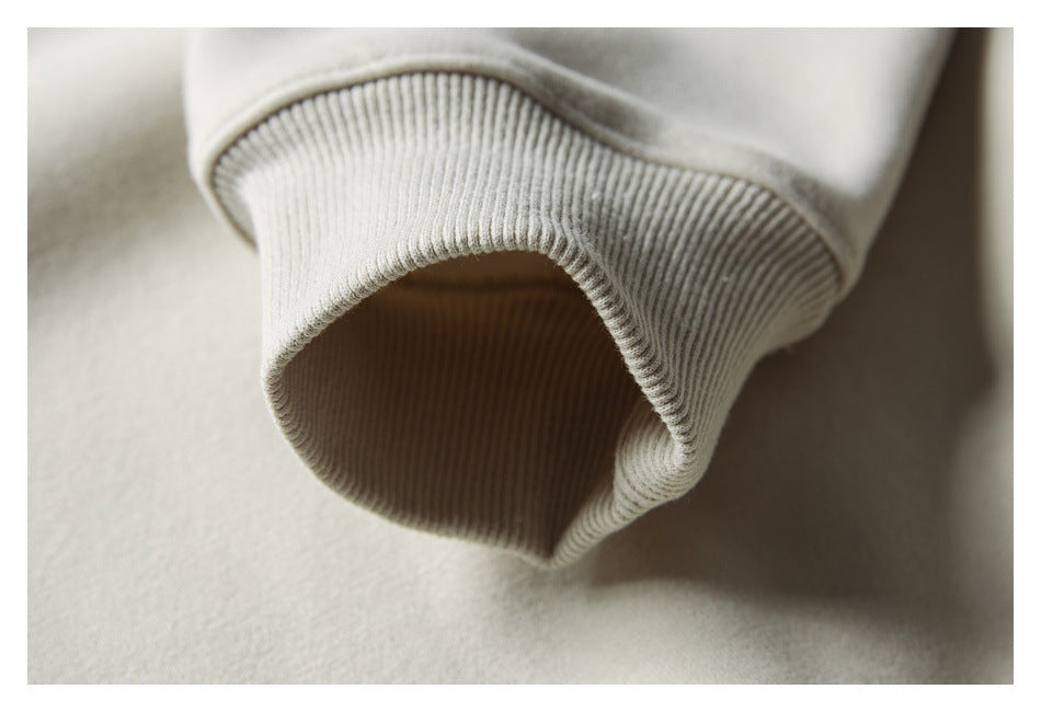 Close-up of a pale cream sleeve ending in a wide ribbed cuff.