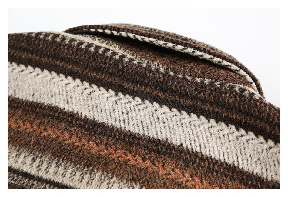 Close-up of a folded collar edge on a brown, rust, cream, and dark plaid garment.